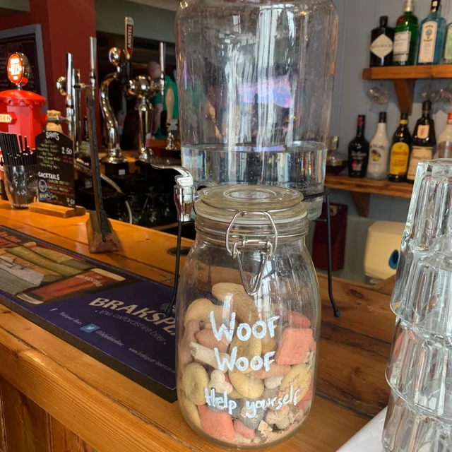 A jar of dog treats with the label "woof woof help yourself" at the Robin Hood